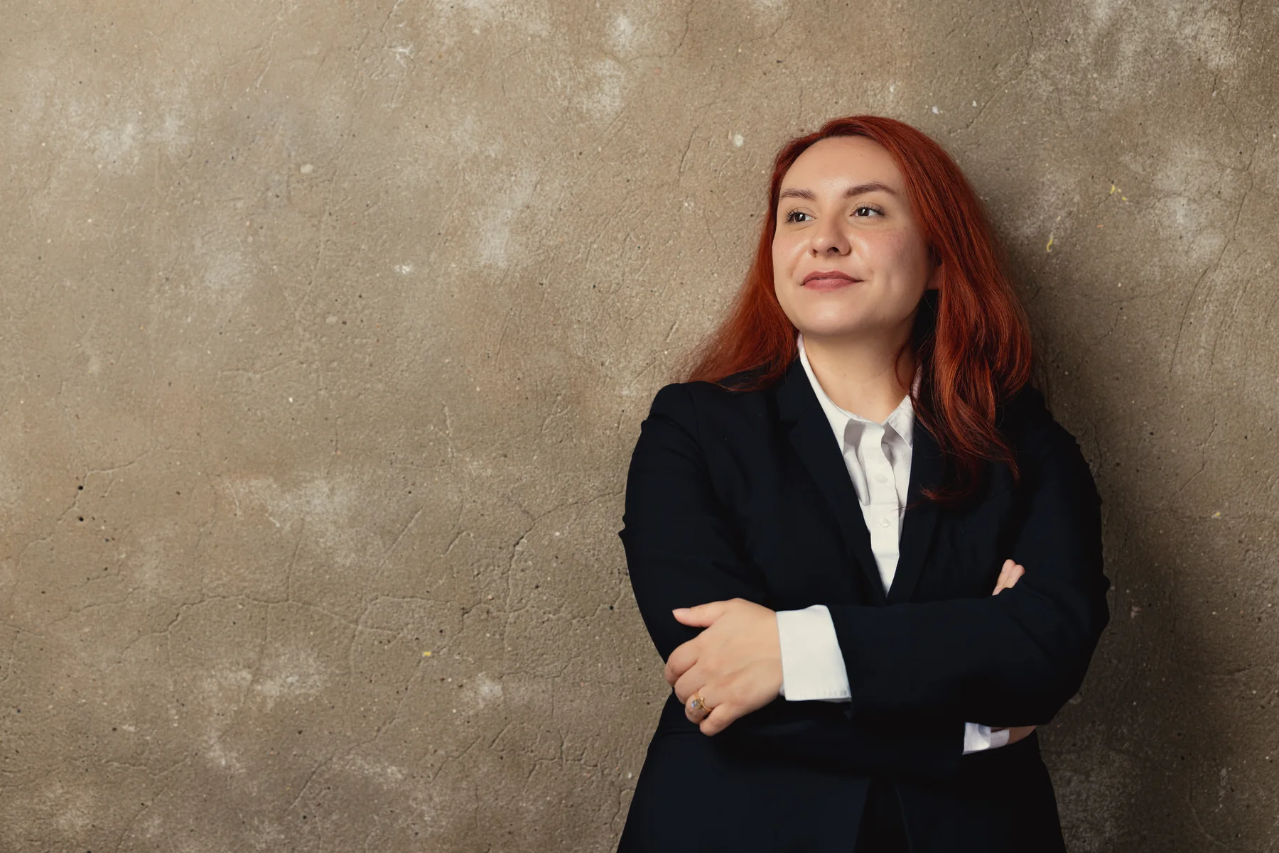 Sara Memi standing against a neutral wall